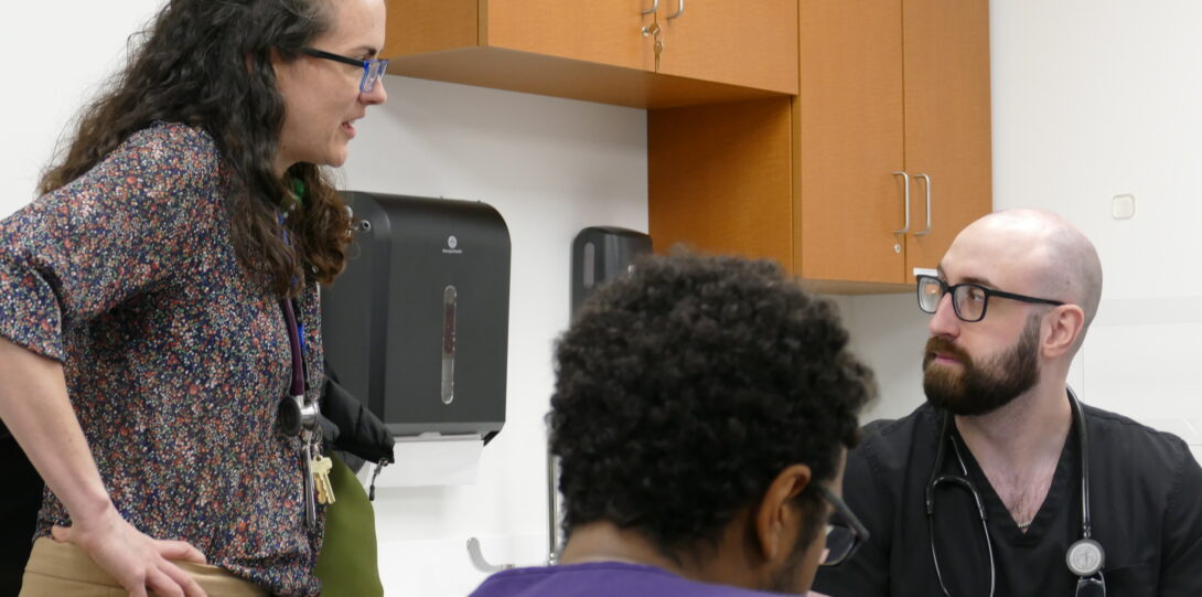 Dr. Erin Hickey conversing with medical students.
